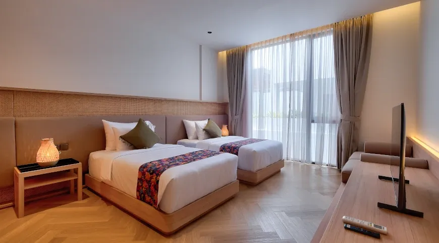 Contemporary bedroom with twin beds and a large window at Villa Brandon