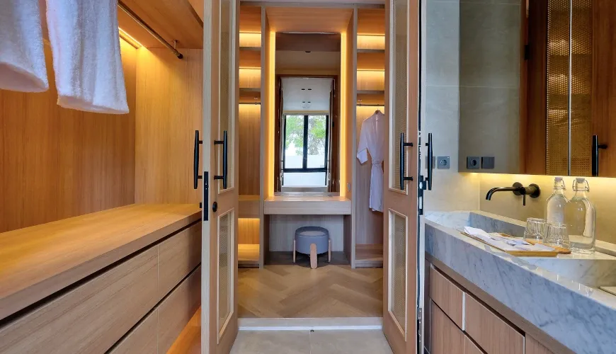Luxury bathroom and dressing area with modern wood cabinetry at Villa Brandon