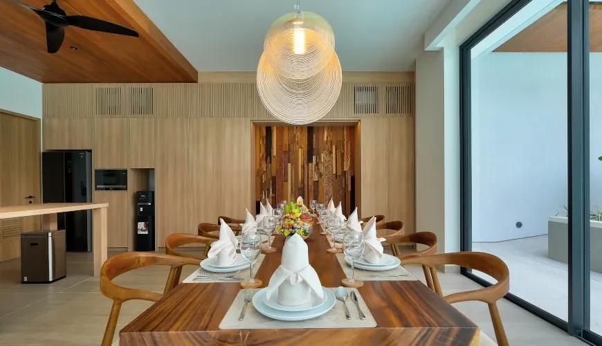 Modern kitchen and dining area with a rustic wooden table at Villa Brandon