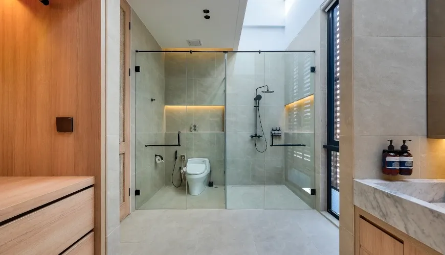 Modern, minimalist bathroom with glass-enclosed shower at Villa Brandon
