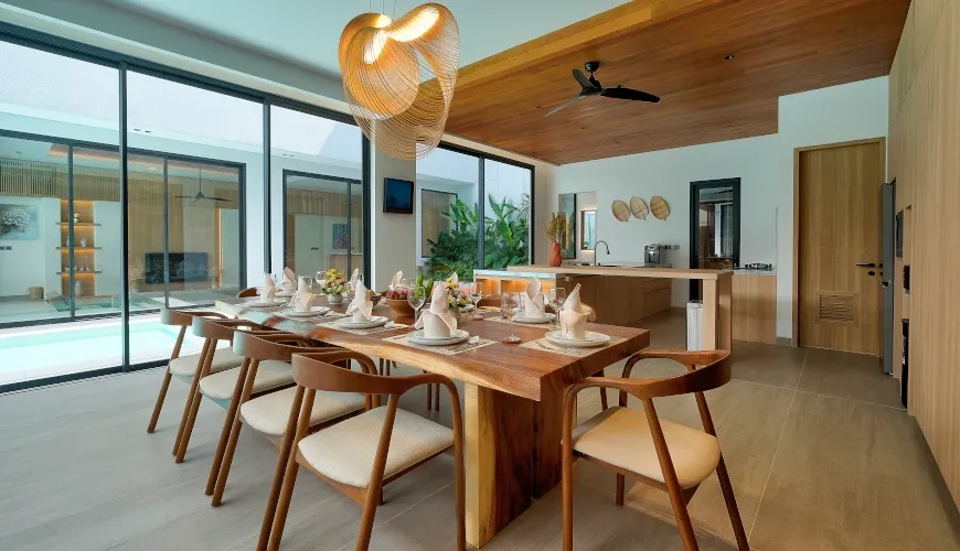 Modern open-plan kitchen and dining area with a wooden table at Villa Brandon