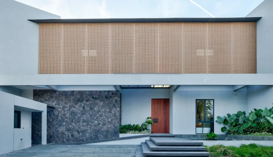 Modern villa entrance with a unique stone facade at Villa Brandon
