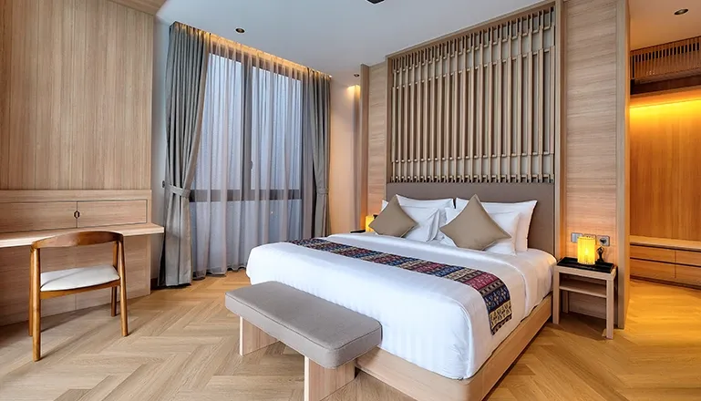 Spacious modern bedroom with a comfortable bed and wood accents at Villa Brandon