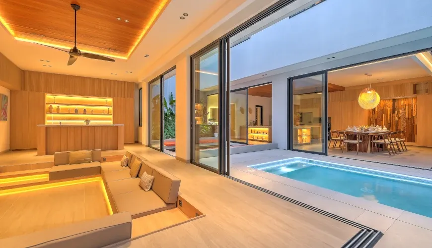 Spacious sunken living room with integrated pool access at Villa Brandon
