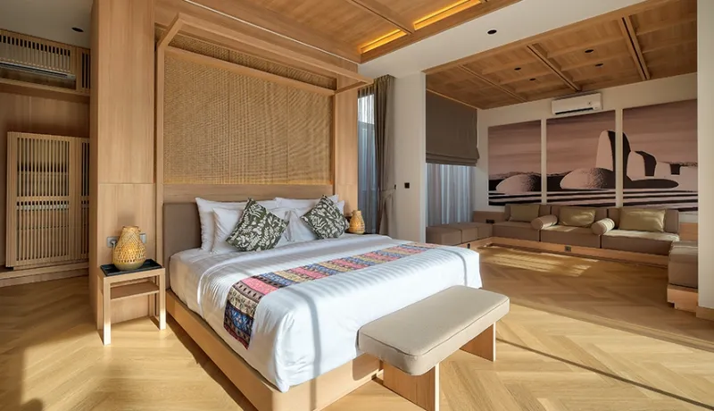 Stylish master suite features a comfortable lounge and striking wall accents at Villa Brandon