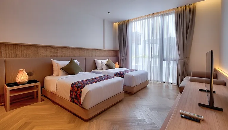 Two single beds in a sunlit modern bedroom at VIlla Brandon