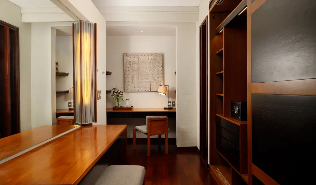 Elegant walk-in closet and vanity with dark wood at Villa Camellia