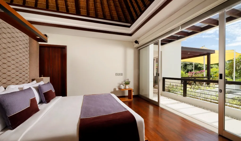 King-sized master bedroom with a private balcony at Villa Camellia