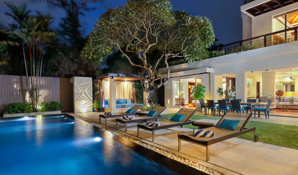 Luxurious villa outdoor pool area lit up at night at Villa Camellia