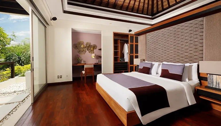 Luxury Bali villa master bedroom with tropical views at Villa Camellia