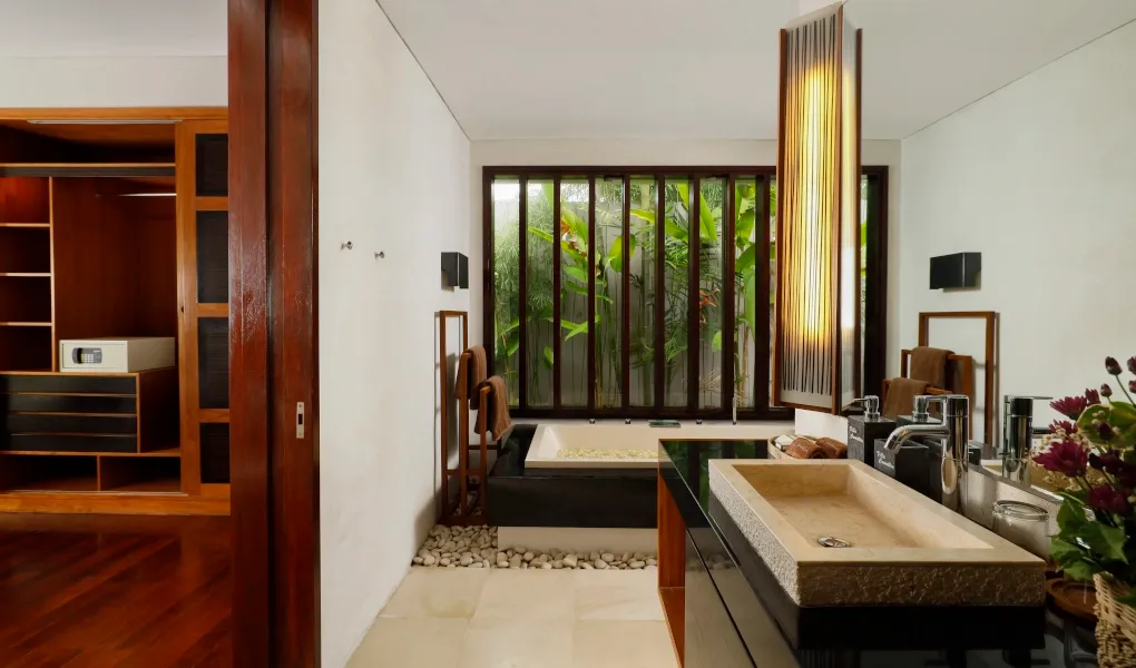 Modern bathroom with a bath and walk-in closet view at Villa Camellia