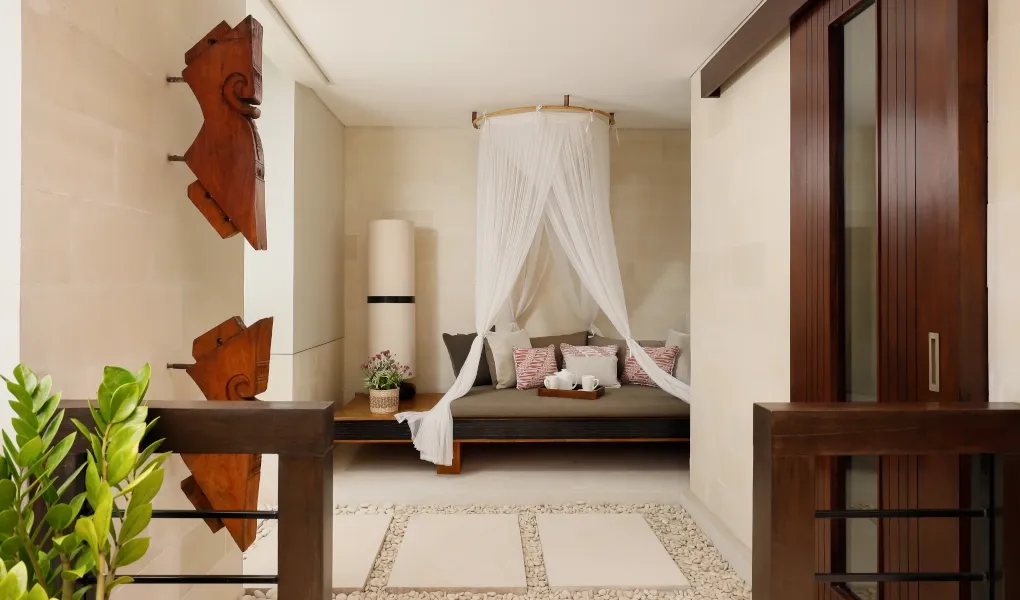 Serene balcony lounge with daybed and traditional art at Villa Camellia