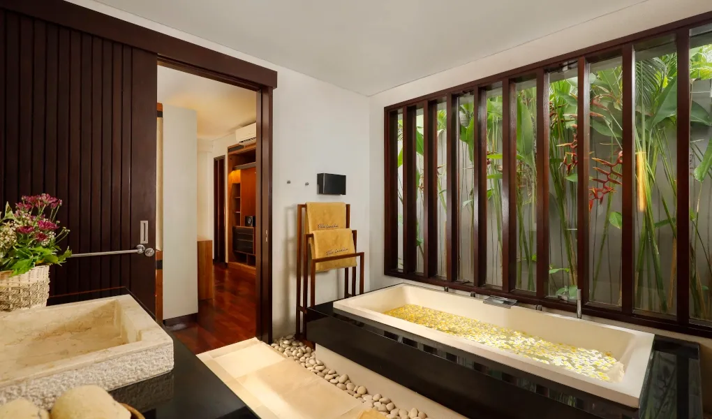Stylish bathroom with a spacious tub and stone sink at Villa Camellia