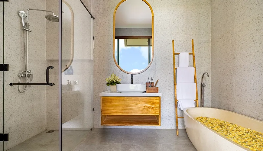 Contemporary guest bathroom featuring a floating wooden vanity, walk-in shower, and decorative bamboo towel ladder at Villa Chanthira Luxe