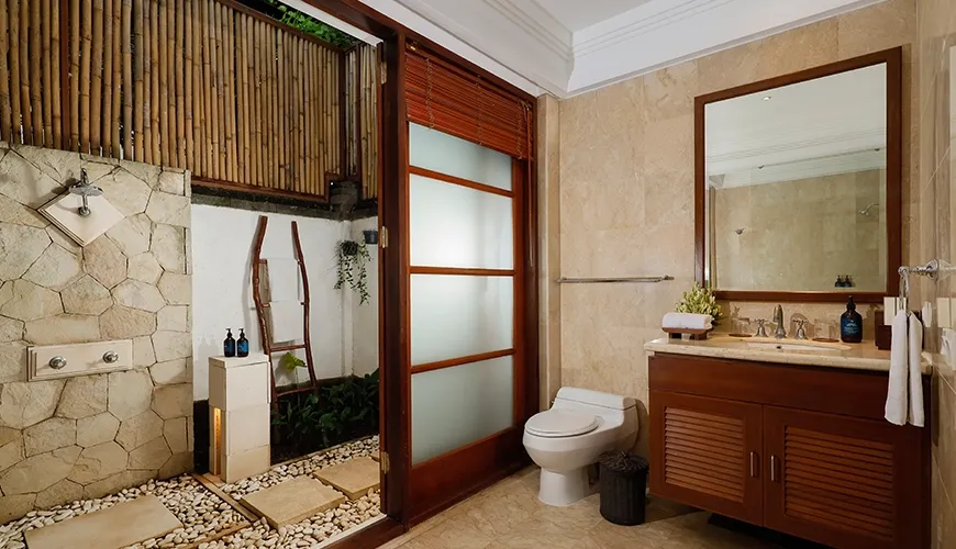 Bright villa bathroom featuring a stone shower and a wooden vanity cabinet at Villa Danis