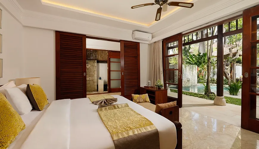 Comfortable and elegant villa bedroom with a spacious bed and direct pool access at Villa Danis