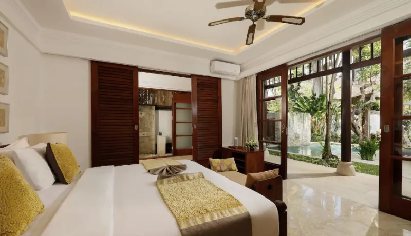 Luxurious bedroom with outdoor pool view at Villa Danis