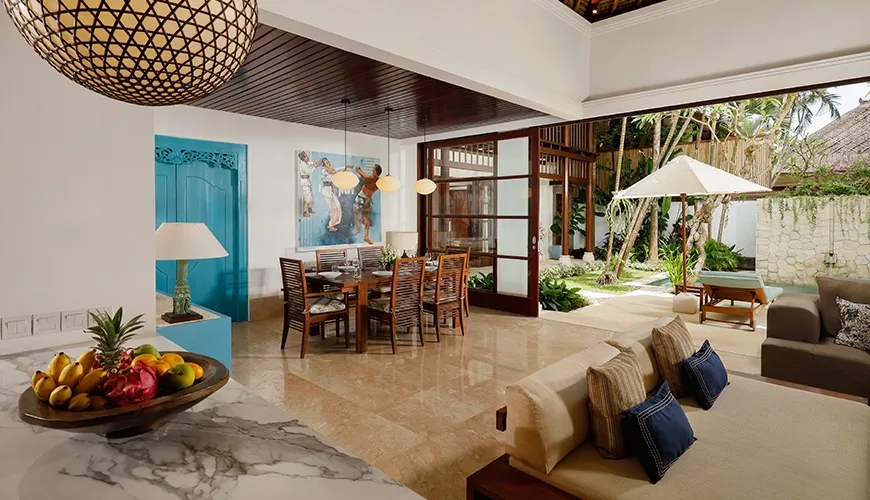 Spacious open-plan villa living area with a dining table and comfortable sofa at Villa Danis