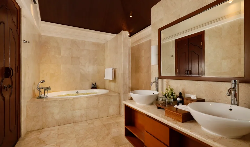 Spa-like bathroom with dual sinks and large tub at Villa Edward