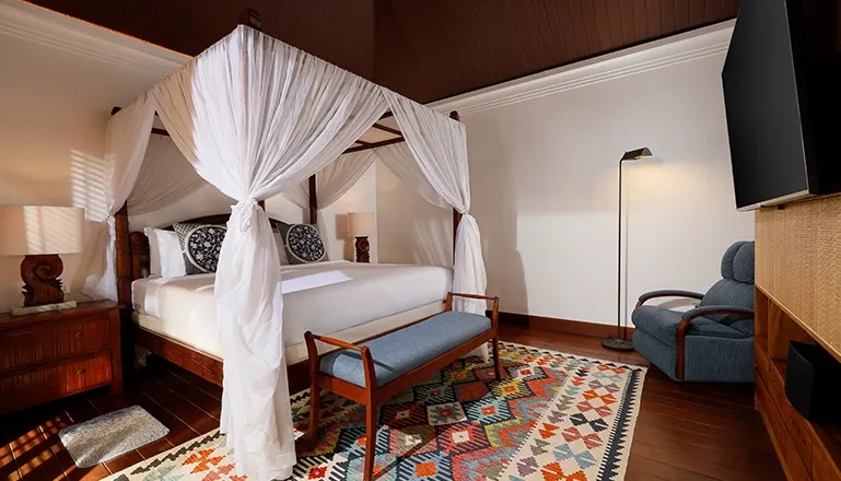 Spacious Bali bedroom with stylish four-poster bed at Villa Edward