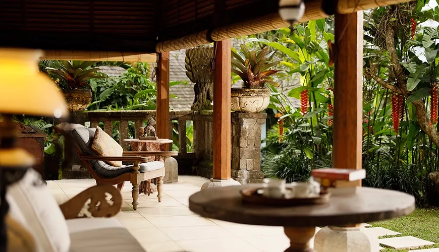 Peaceful outdoor villa terrace featuring traditional wooden furniture and beautiful tropical plants, perfect for relaxing at Villa Inka