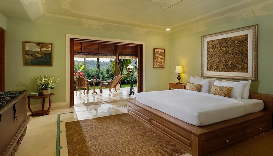 Serene villa bedroom with a comfortable king-size bed, featuring traditional furniture and beautiful outdoor views at Villa Inka