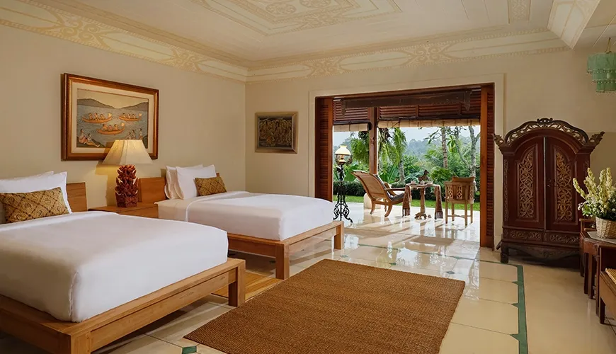 Spacious twin bedroom of a tropical villa with a large window and outdoor terrace area at Villa Inka