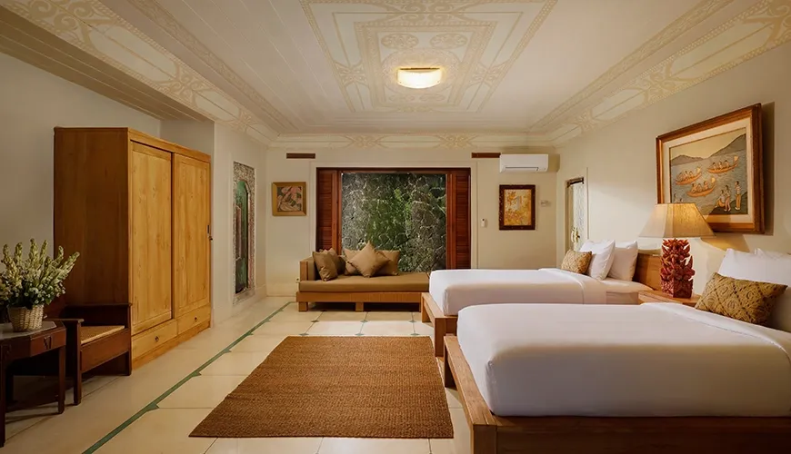 Spacious villa twin bedroom with two comfortable beds and traditional wooden furniture, featuring a serene daybed area at Villa Inka