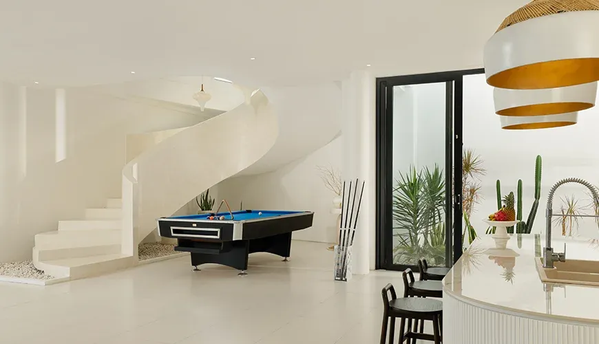 Modern billiards room with a spiral staircase at Villa Kalem Canggu