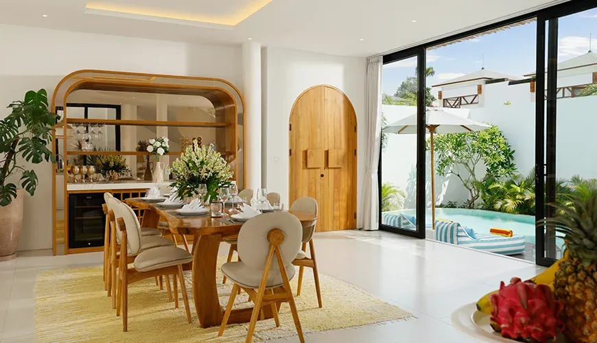 Spacious dining area featuring comfortable chairs and plants at Villa Kalem Canggu