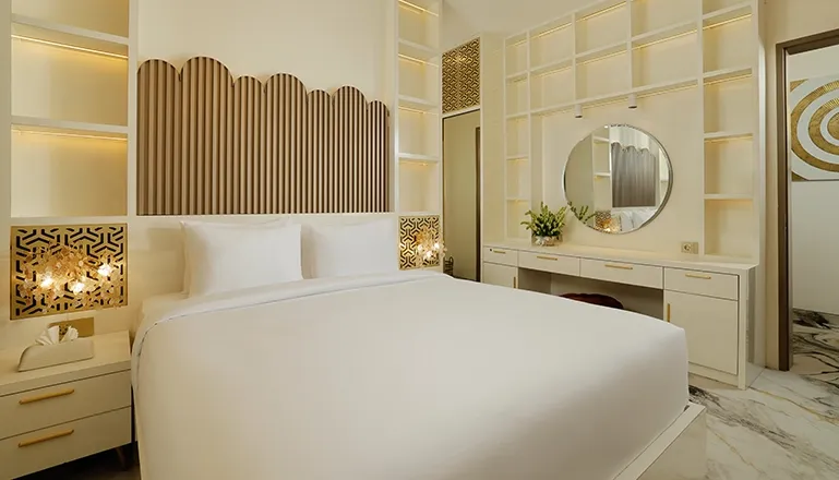 Elegant bedroom white bed decorative headboard built-in shelves modern vanity mirror at Villa Kalem Uluwatu