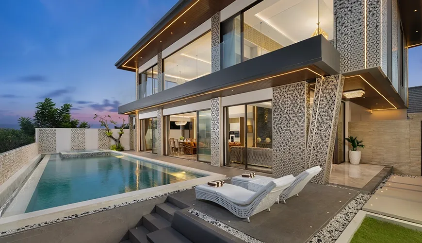 Modern luxury villa private pool outdoor lounge chairs architectural design at Villa Kalem Uluwatu