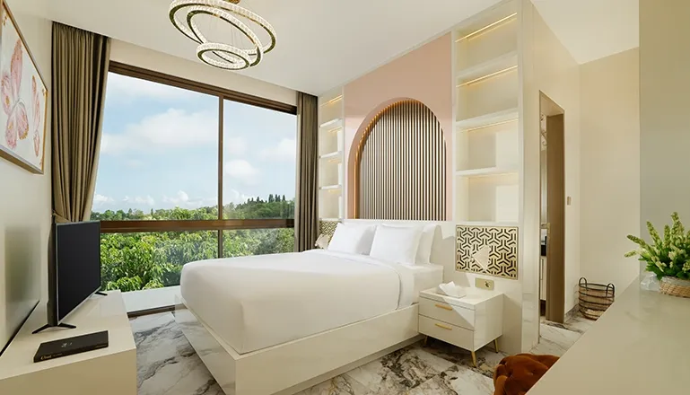 Stylish bedroom white bed modern chandelier large window green view at Villa Kalem Uluwatu