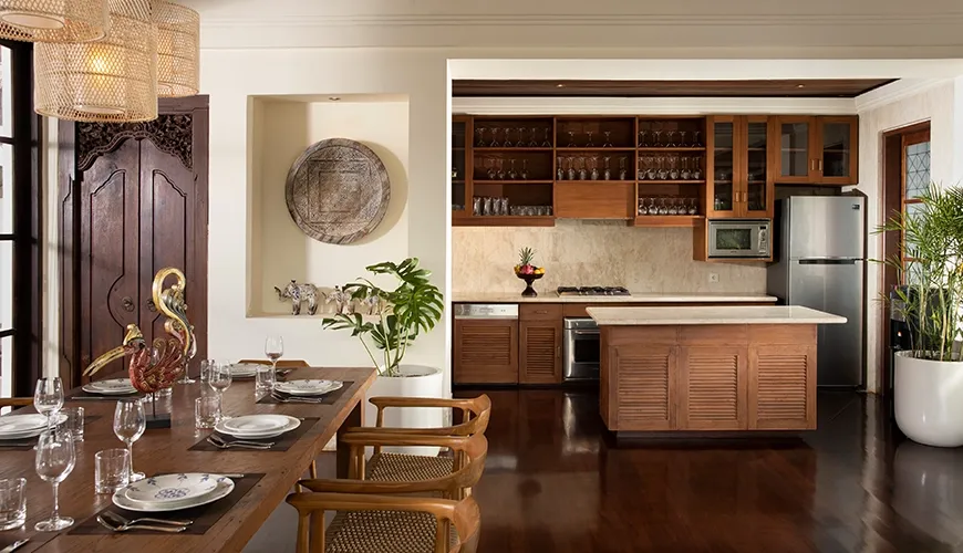 Fully equipped modern kitchen with wooden cabinets and island at Villa Ken