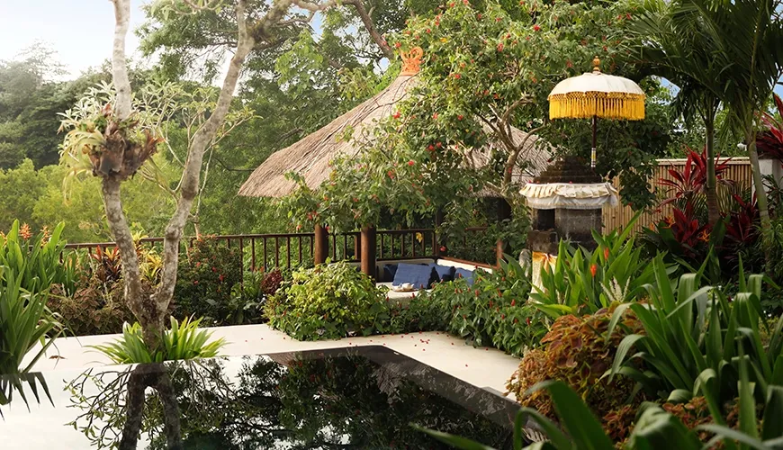 Lush garden with traditional gazebo water feature and shrine at Villa Ken
