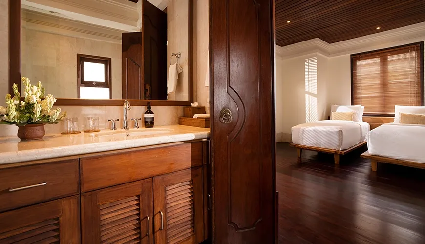 Luxurious and well-lit private villa bathroom vanity with a spacious countertop and direct access to the bedroom at Villa Ken