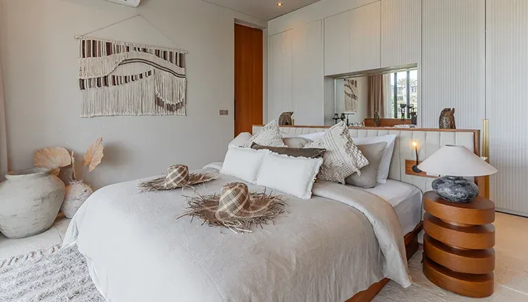 Beautiful bedroom with a minimalist aesthetic and wooden accents at Villa Morada