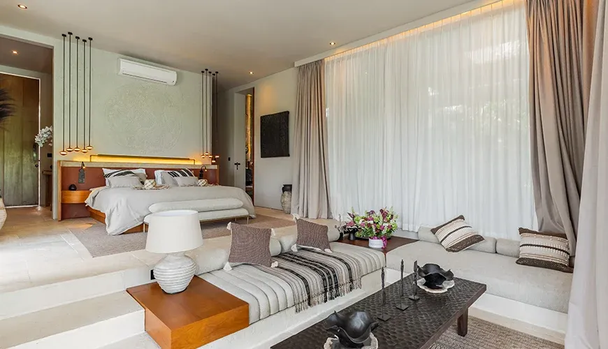 Elegant master suite featuring a bed and cozy lounge at Villa Morada