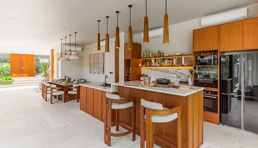 Modern kitchen with a large island and bar stools ar Villa Morada