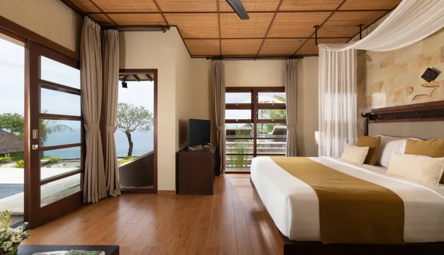 Bedroom with ocean view and a four-poster bed at Naga Sutra Villa