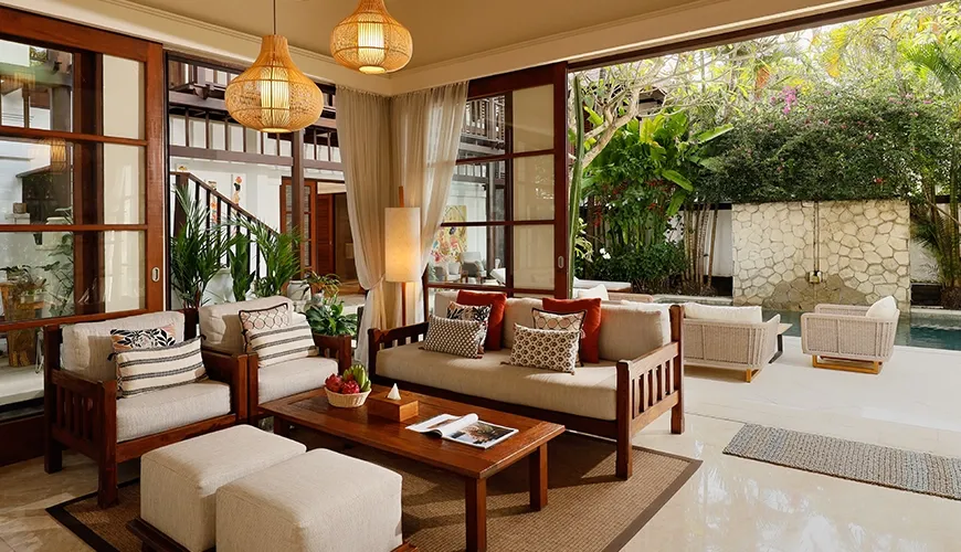 Beautifully designed villa living area with warm natural light and comfortable handcrafted wooden furniture at Villa Nayra