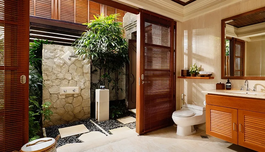 Contemporary villa bathroom with a stylish wooden vanity and an incredible outdoor stone shower at Villa Nayra