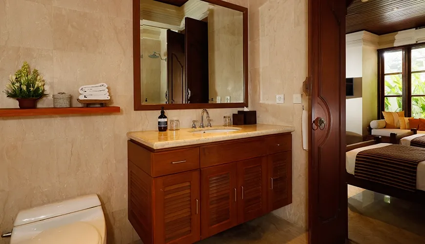 Elegant and clean villa bathroom with a beautiful wooden vanity and luxurious marble countertop at Villa Nayra