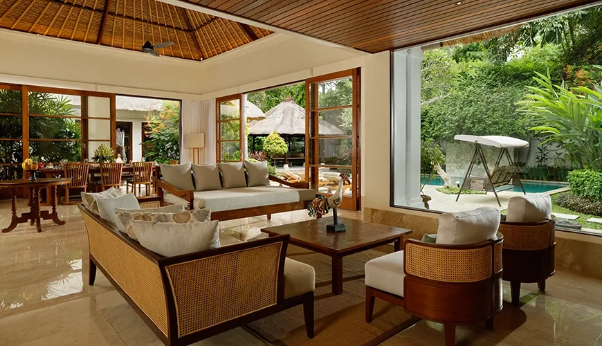 Luxurious villa living area with comfortable rattan furniture, marble floor, and stunning view of a tropical garden at Villa Ohm