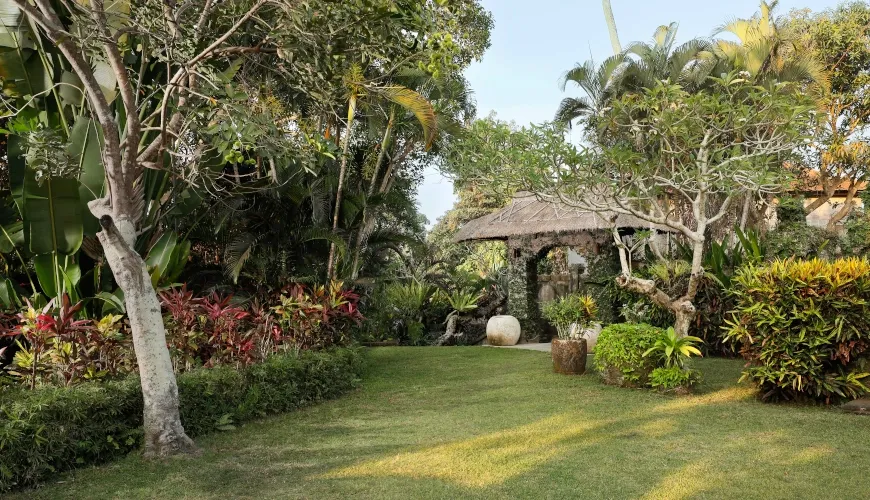 Lush tropical garden with traditional Bali entrance gate at Villa Omecure