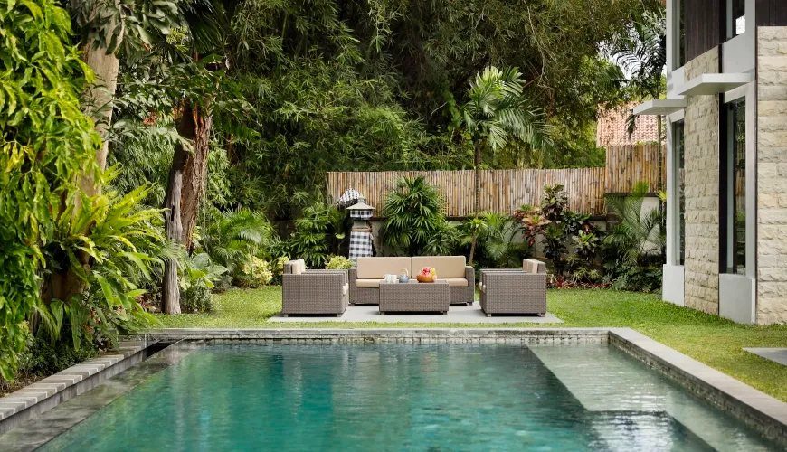 Balinese villa with outdoor lounge furniture next to a private pool at Villa Omekali