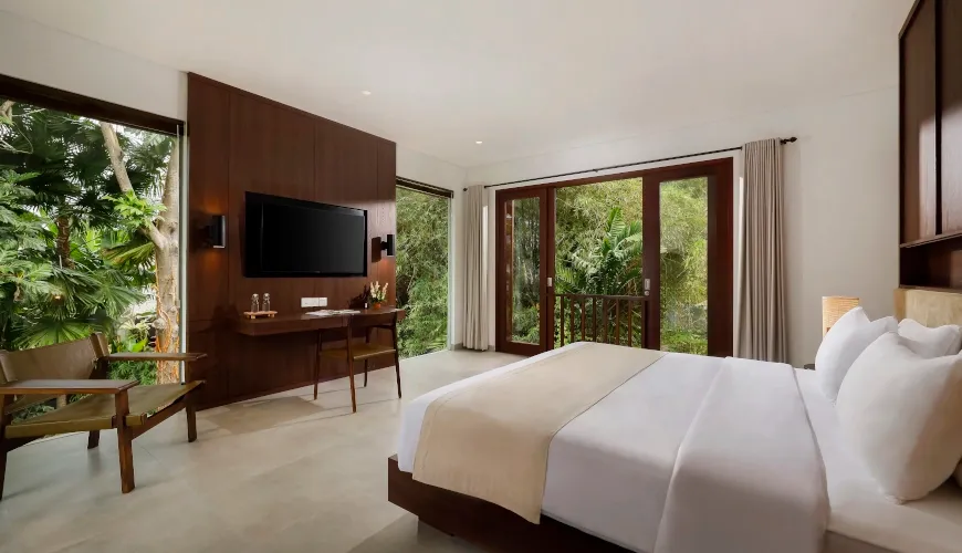 Modern Bali bedroom with tropical jungle views and sliding glass doors at Villa Omekali