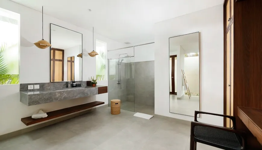 Spacious modern bathroom with floating vanity and walk-in shower at Villa Omekali
