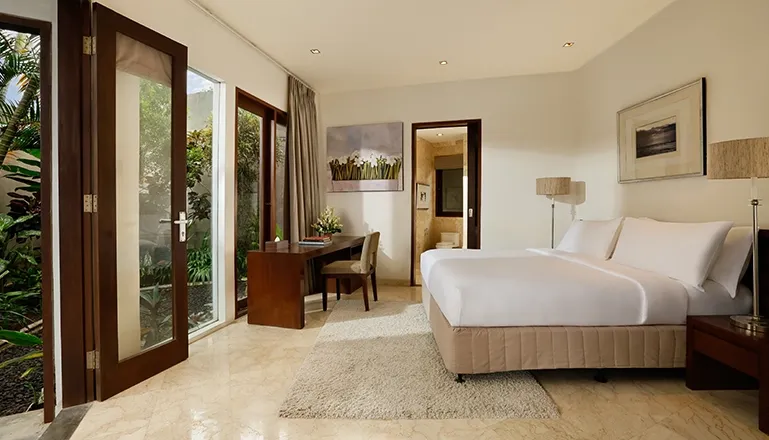 Bedroom with bed desk and en-suite bathroom access at Villa Oshra