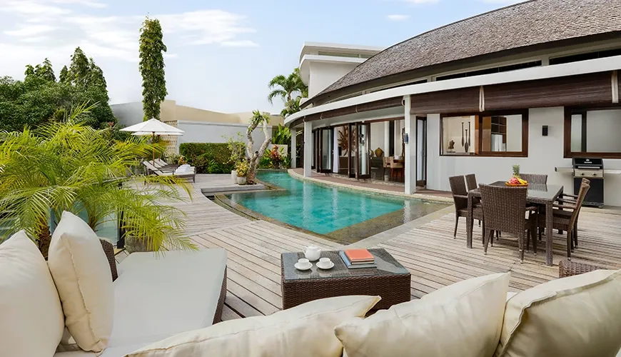 Luxurious tropical villa with a beautiful private swimming pool surrounded by a large wooden deck at Villa Oshra